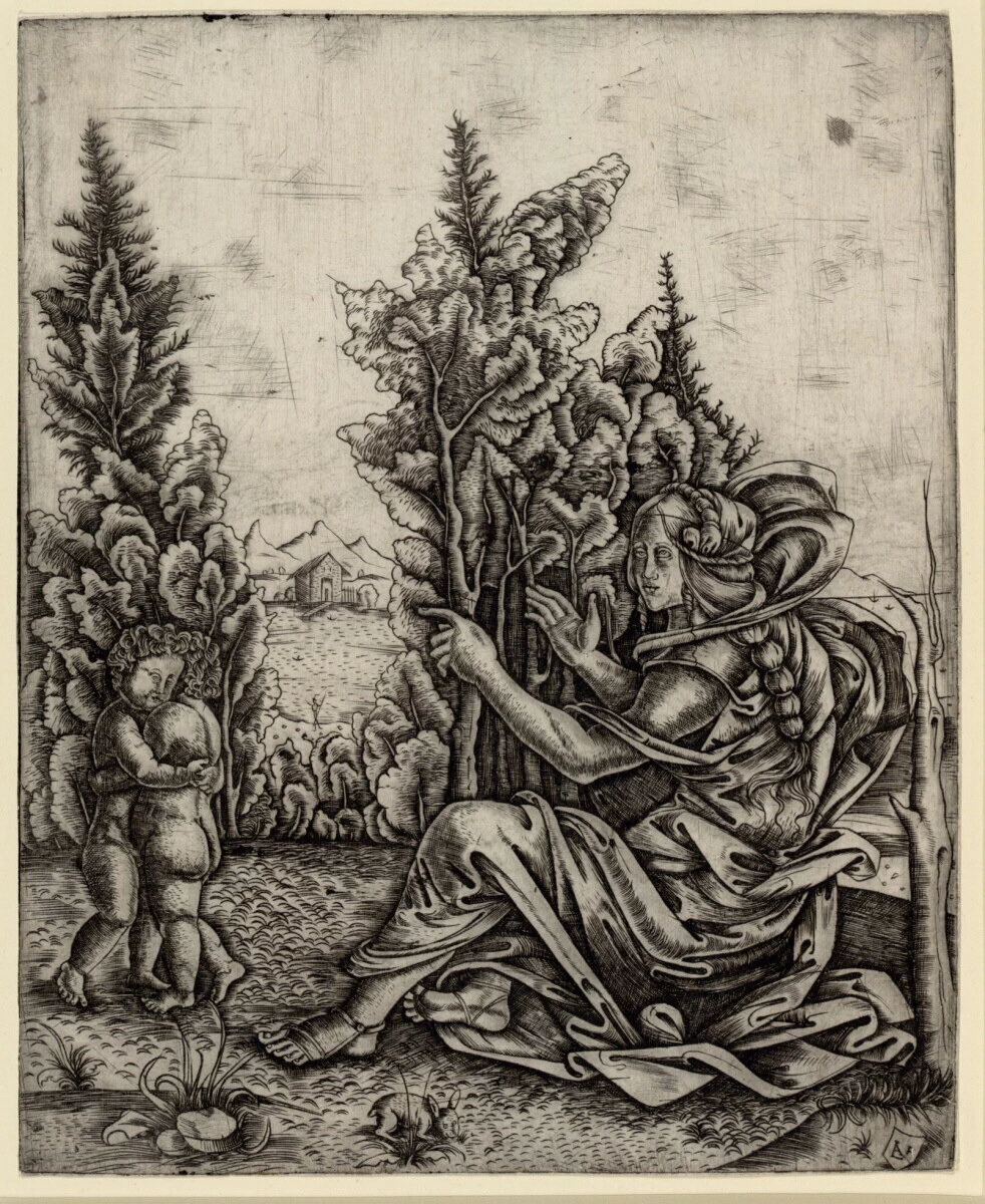 Donna seduta con due bambini in campagna